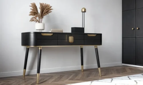 Black and brass console table with geometric details and dried pampas grass arrangement