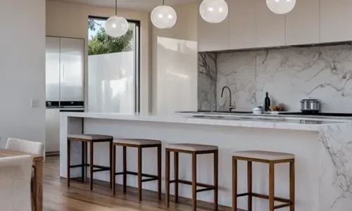 Modern white kitchen featuring marble backsplash, globe pendants, and wooden bar stools