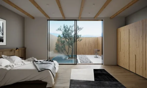 Zen-inspired bedroom featuring sliding glass doors overlooking private garden with reflecting pool